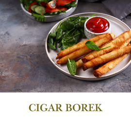Cigar Borek is a crisp, thin pastry filled with cheese, rolled into a cigar shape, and fried to perfection.
